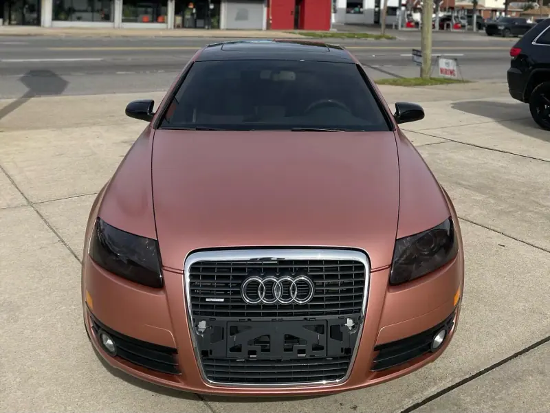 Satin rose gold Audi A6, front view on the street