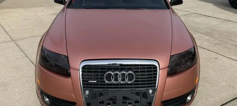 Satin rose gold Audi A6, front view, wide crop