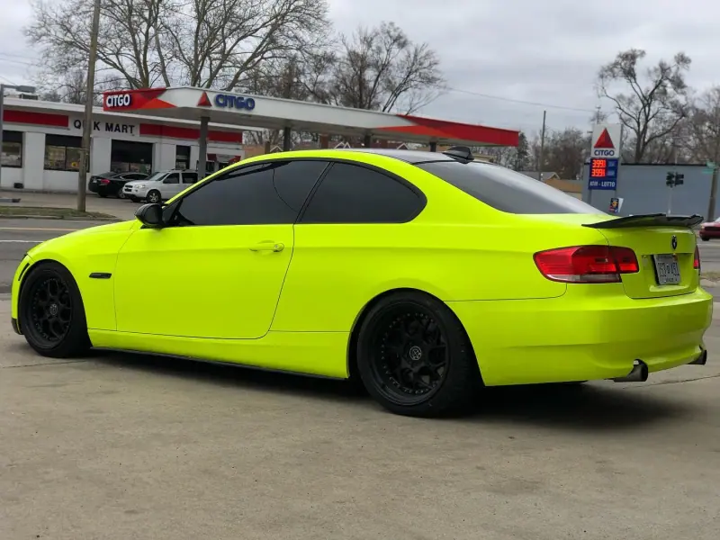 Lime green BMW 3 series coupe, side view on the street