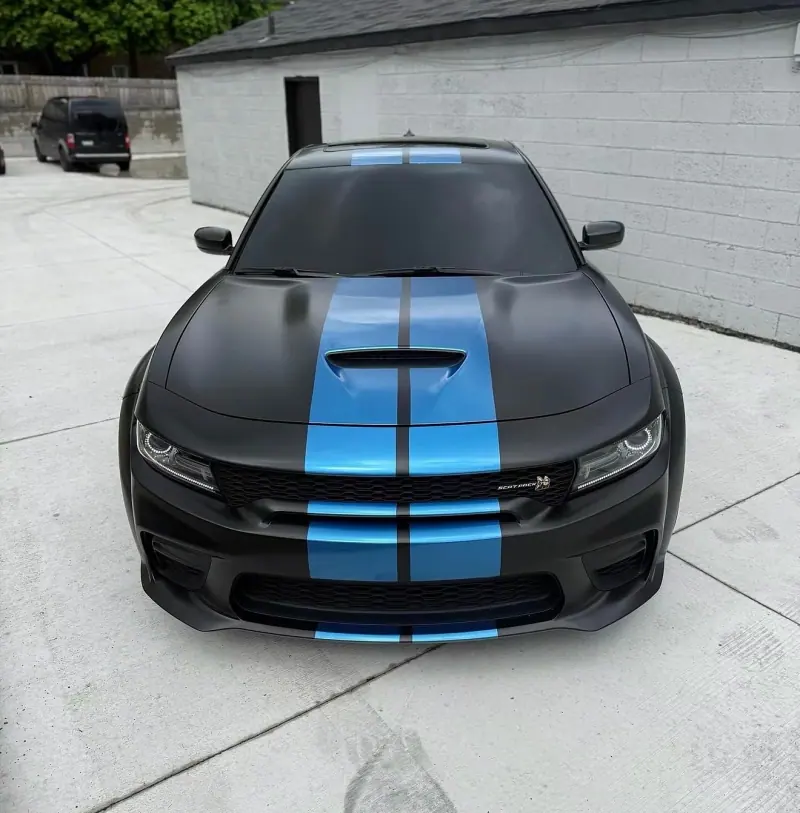 Matte black Dodge Charger with blue stripes, front view