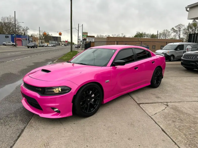 Gloss pink Dodge Charger, front three quarter view on the street