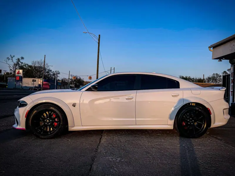 White Dodge Charger, side view at dusk
