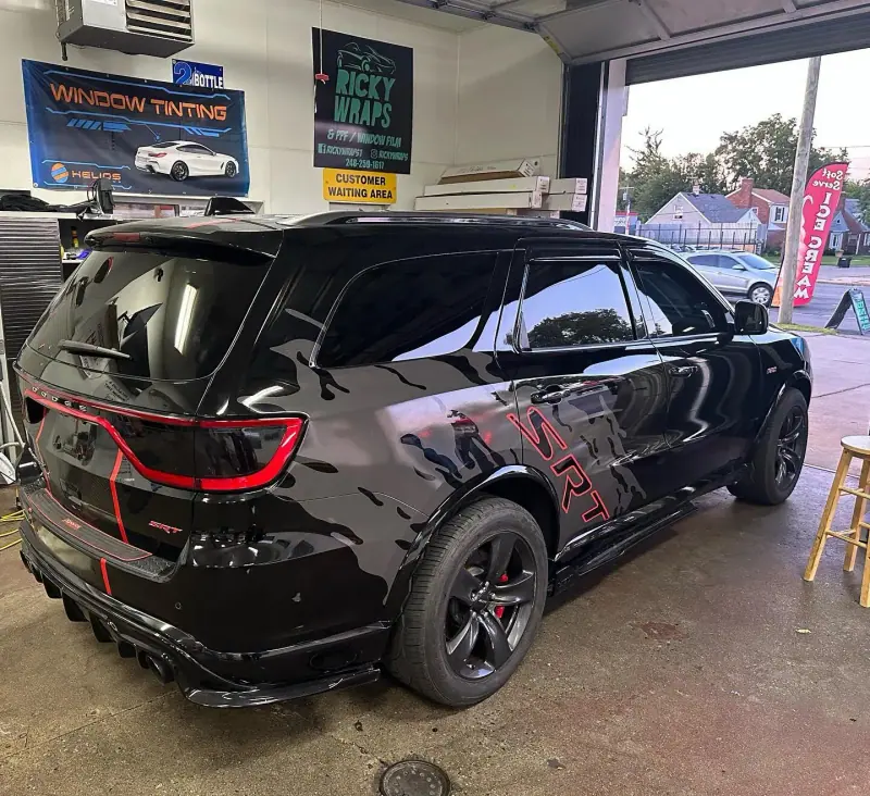 Black Dodge Durango with red accents, rear view inside the shop