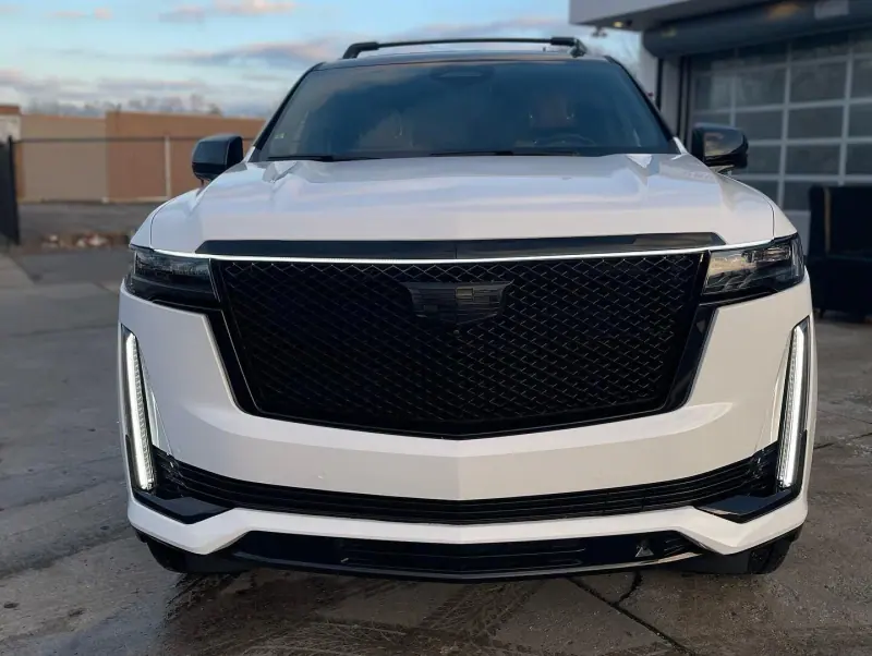 White Cadillac Escalade, front view in the shop doorway