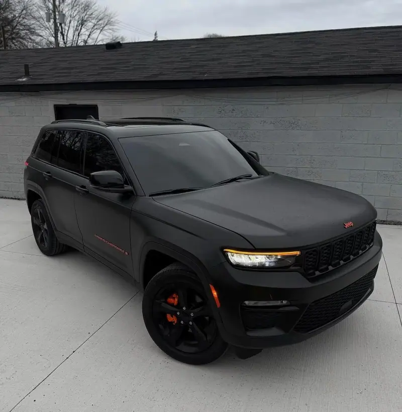 Matte black Jeep Grand Cherokee, front three quarter view