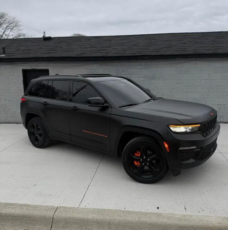 Matte black Jeep Grand Cherokee, side view