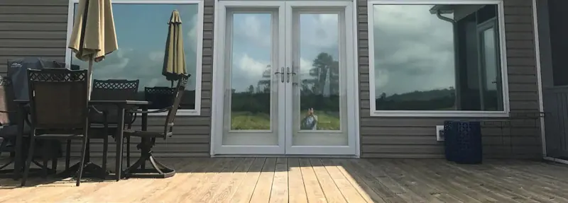 Sliding glass doors with window film on a back deck