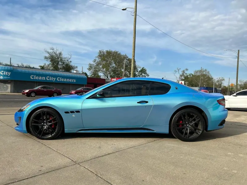 Light blue Maserati GranTurismo, side view on the street
