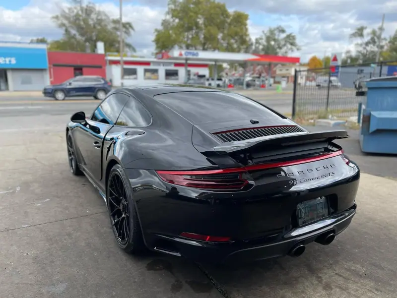 Black Porsche 911, rear three quarter view