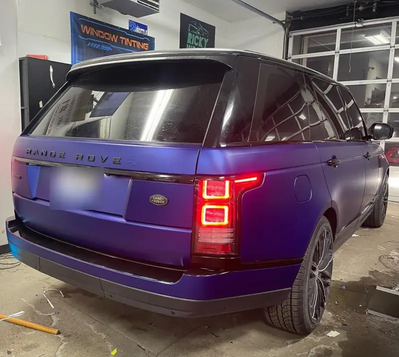 Satin purple Range Rover, rear three quarter view inside the shop