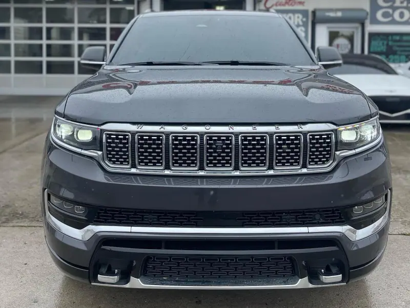 Gray Jeep Grand Wagoneer, front view