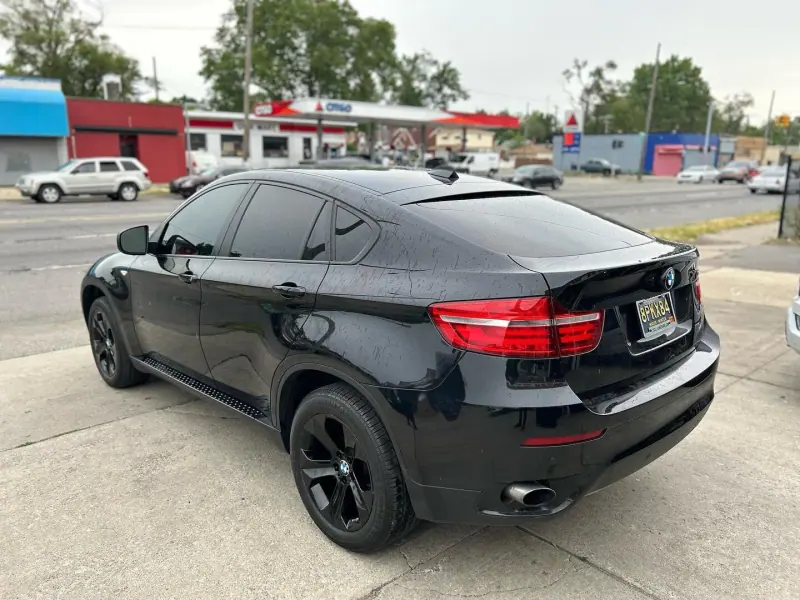 Black BMW X6, rear view on the street